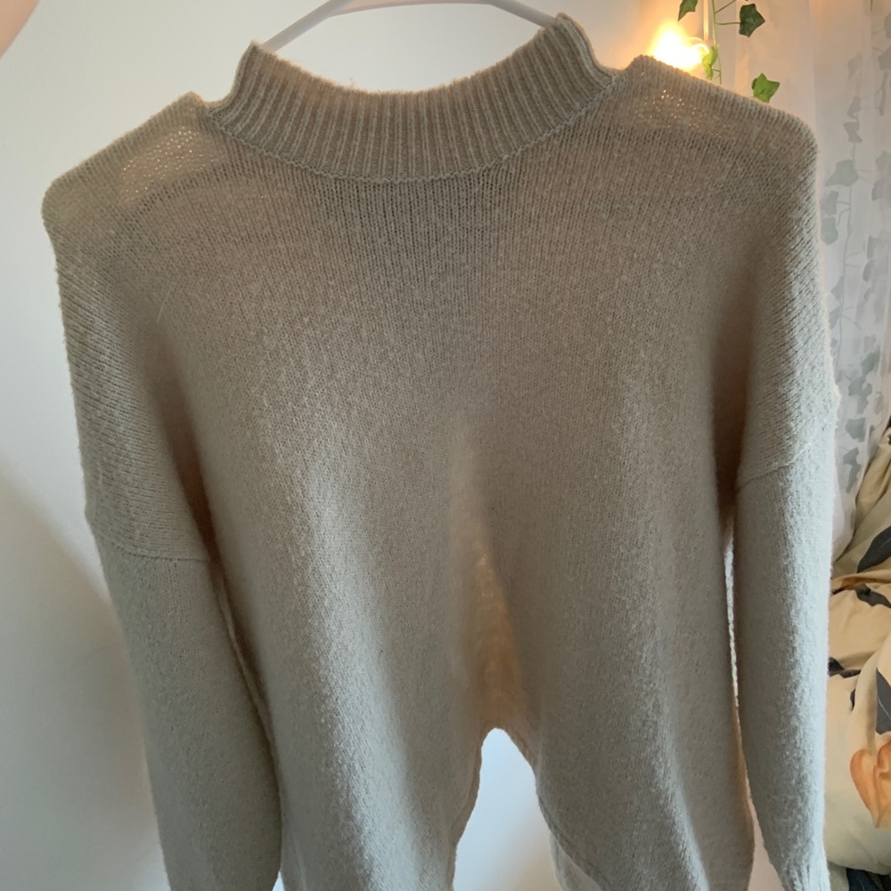 Tan, low turtleneck sweater